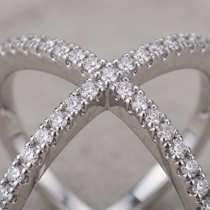 Close-up of the crossing silver bands and round moissanite stones on the Vellmonto Axis ring.