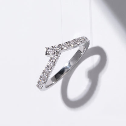 Vellmonto Rush silver moissanite chevron ring casting a curved shadow on a white background.